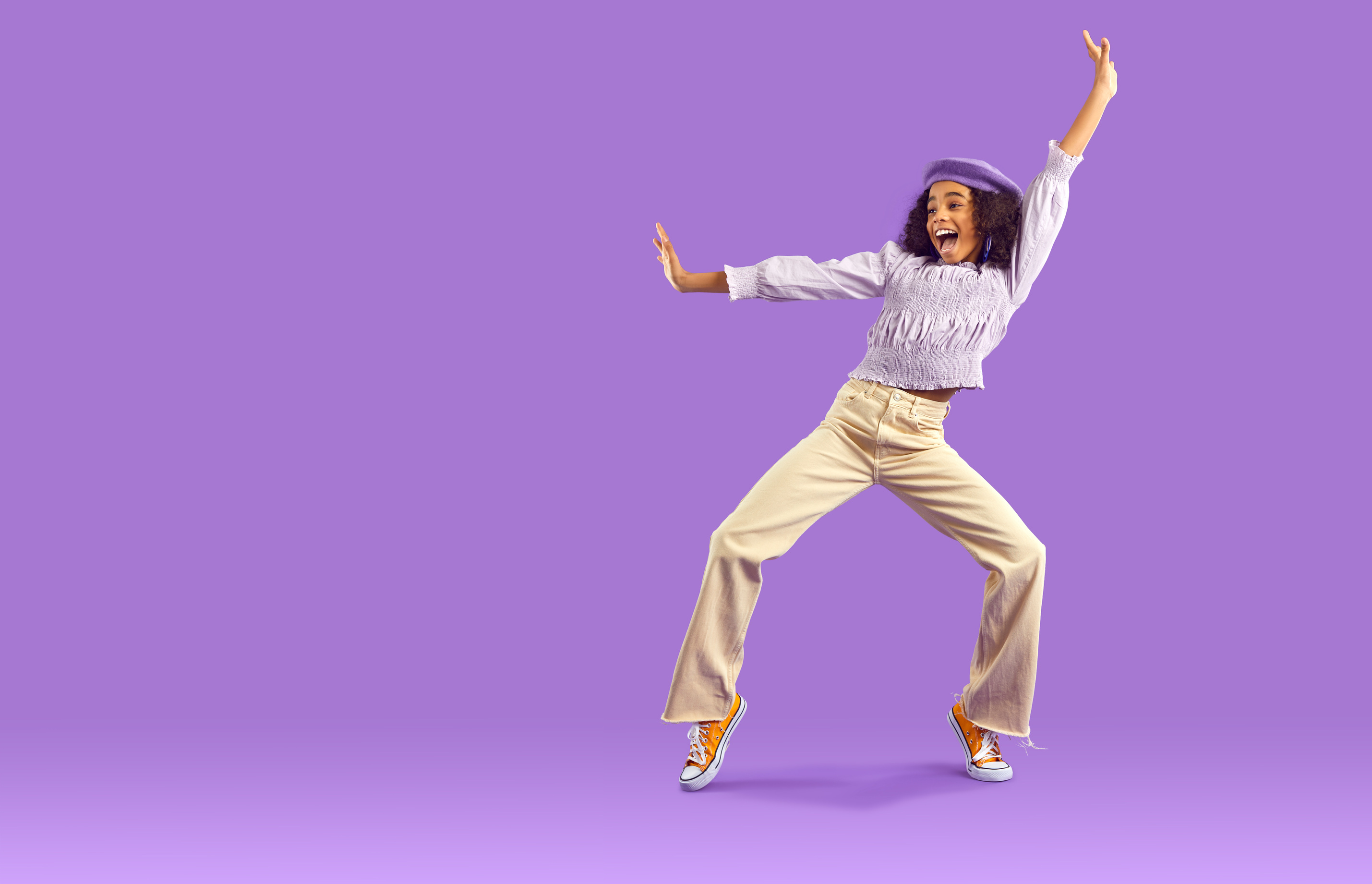 Funny Black Teen Girl Dancing on Purple Background